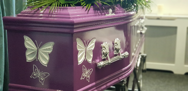 Purple coffin with engraved butterflies painted whited